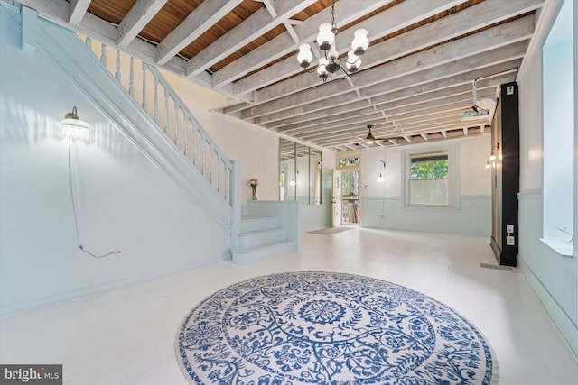 5811 Mcmahon St, Philadelphia, PA 19144 - foyer with stairway, a chandelier, ceiling fan, and a wainscoted wall