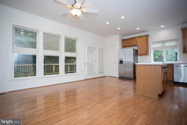 30 Dayton Cir, Fredericksburg, VA 22406 - kitchen featuring stainless steel appliances, light countertops, a center island, light wood-type flooring, and brown cabinetry