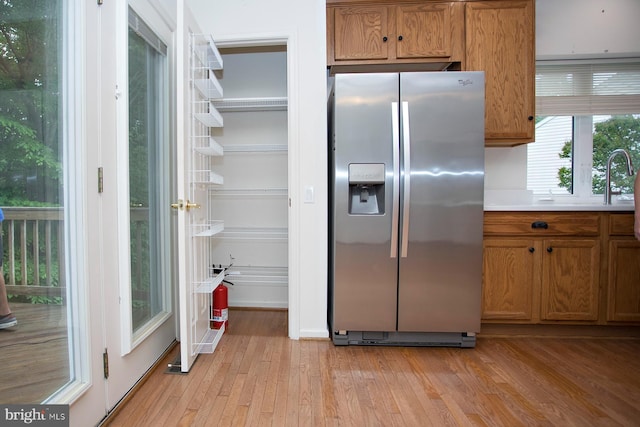 30 Dayton Cir, Fredericksburg, VA 22406 - kitchen with stainless steel fridge with ice dispenser, light wood-style floors, brown cabinetry, and light countertops