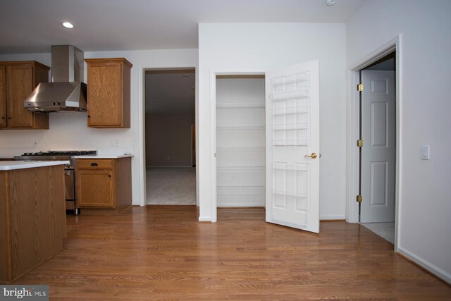 30 Dayton Cir, Fredericksburg, VA 22406 - kitchen featuring wall chimney range hood, high end stove, brown cabinets, wood finished floors, and recessed lighting