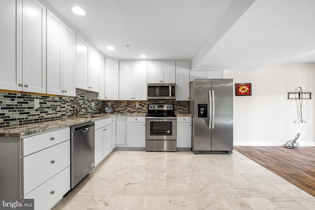 3615 Amber Way, Aberdeen, MD 21001 - kitchen featuring appliances with stainless steel finishes, a sink, light marble finish floors, decorative backsplash, and stone counters