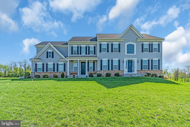 view of front of property with a front lawn and stone siding