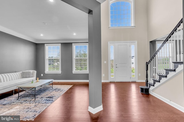entrance foyer with stairway, hardwood / wood-style flooring, baseboards, recessed lighting, and crown molding