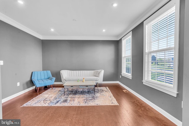 sitting room featuring crown molding, wood finished floors, baseboards, and recessed lighting