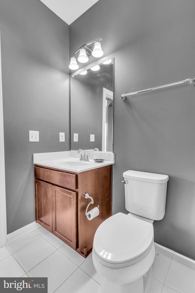 bathroom featuring tile patterned floors, vanity, toilet, and baseboards