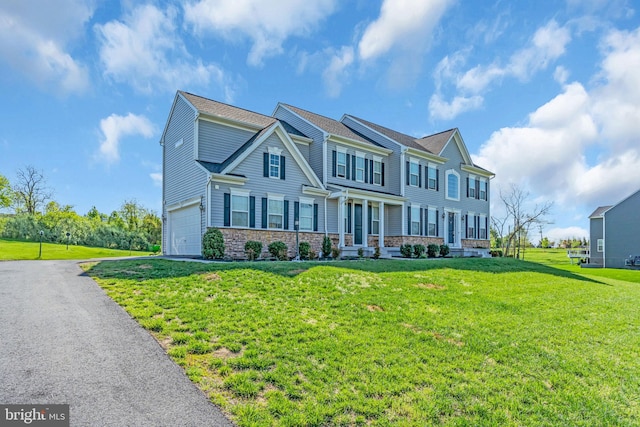 view of front of home featuring a front lawn and a garage