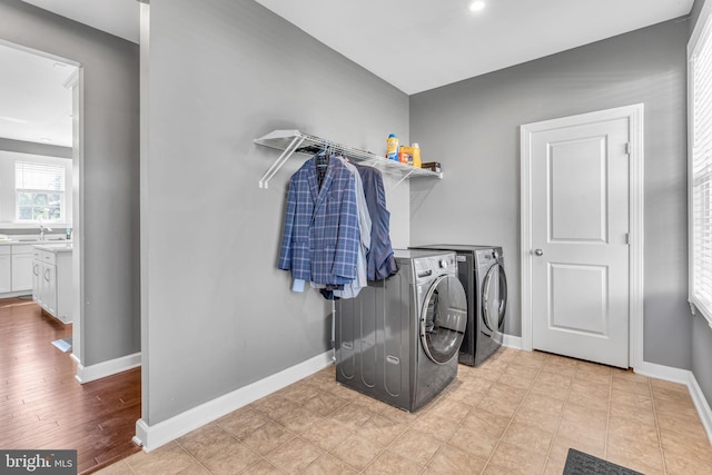 laundry area featuring washer and clothes dryer and baseboards