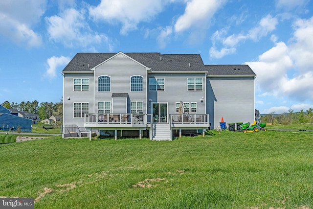 back of property featuring a deck and a yard