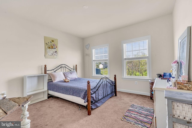 carpeted bedroom with baseboards