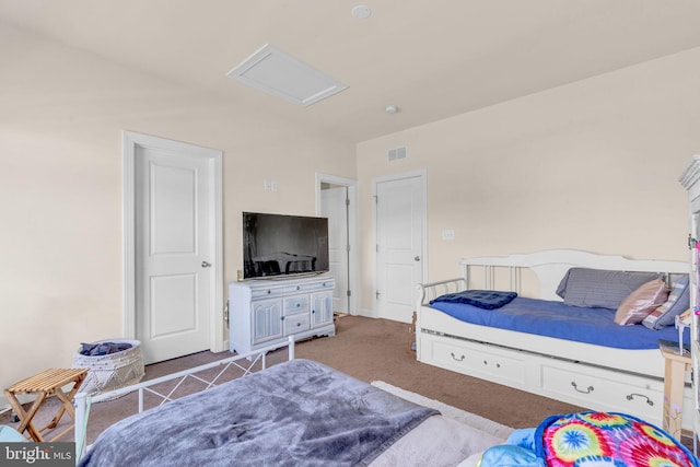bedroom with attic access and carpet