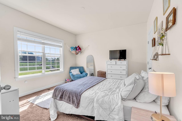 carpeted bedroom with baseboards