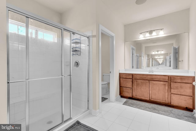 full bathroom with a shower stall, toilet, vanity, and tile patterned flooring