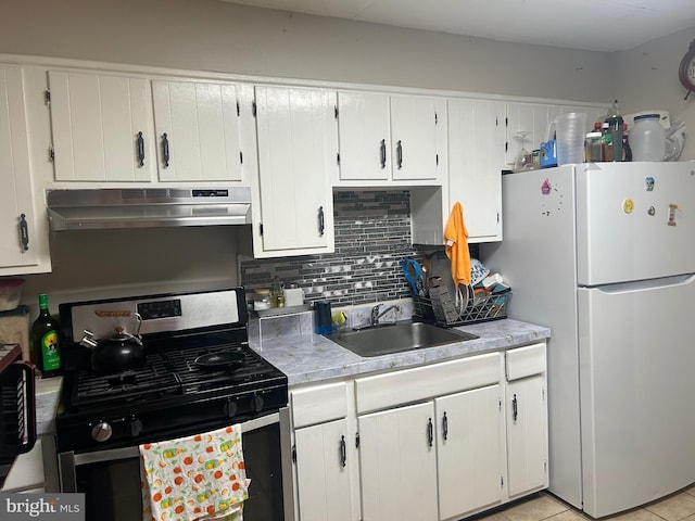 1110 Hamilton Ave, Trenton, NJ 08629 - kitchen with gas stove, freestanding refrigerator, under cabinet range hood, decorative backsplash, and a sink