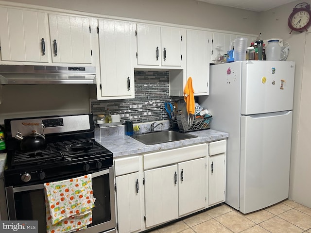 1110 Hamilton Ave, Trenton, NJ 08629 - kitchen with gas range, freestanding refrigerator, under cabinet range hood, a sink, and decorative backsplash