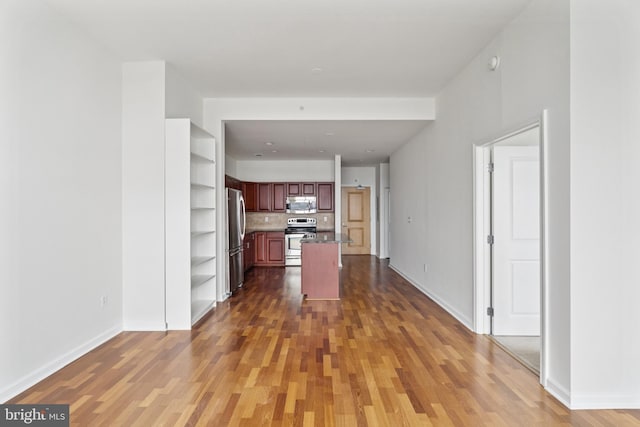 901 N Penn St Unit F1504, Philadelphia, PA 19123 - kitchen with appliances with stainless steel finishes, open shelves, wood finished floors, baseboards, and a center island