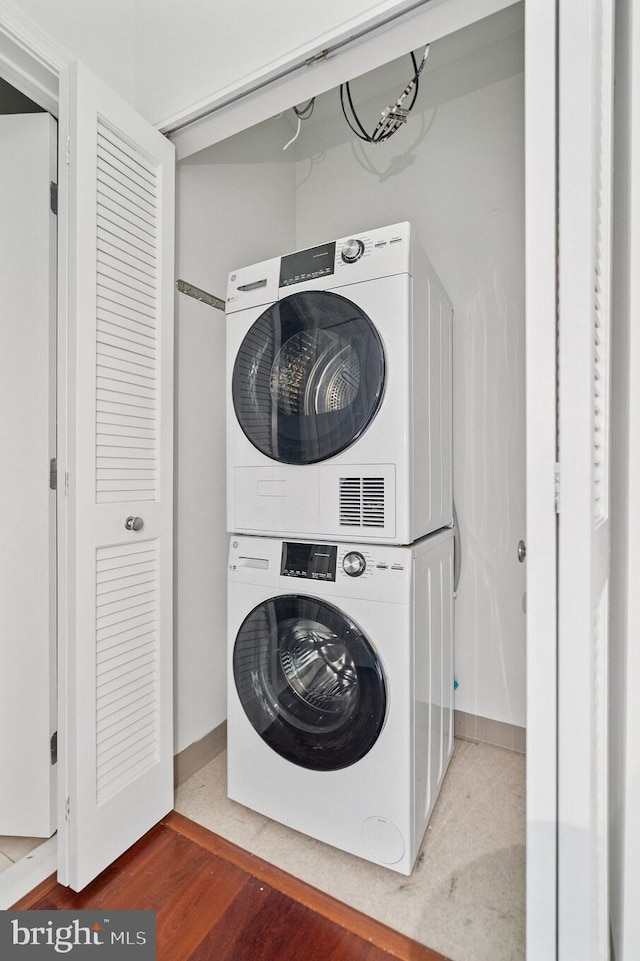 901 N Penn St Unit F1504, Philadelphia, PA 19123 - laundry area featuring estacked washer and dryer and wood finished floors