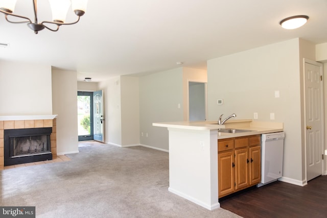 1615 Foxmeadow Cir Unit 1615, Royersford, PA 19468 - kitchen with dishwasher, a sink, open floor plan, light countertops, and a fireplace
