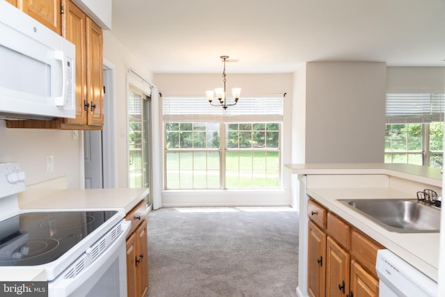 1615 Foxmeadow Cir Unit 1615, Royersford, PA 19468 - kitchen featuring white appliances, carpet, a chandelier, and healthy amount of natural light