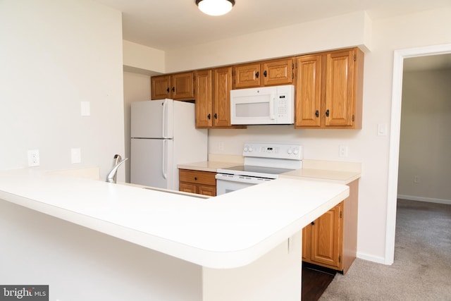 1615 Foxmeadow Cir Unit 1615, Royersford, PA 19468 - kitchen featuring white appliances, light countertops, a peninsula, dark colored carpet, and baseboards