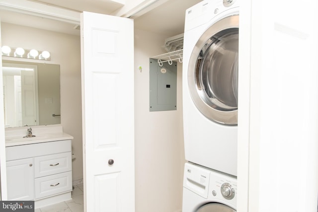 1615 Foxmeadow Cir Unit 1615, Royersford, PA 19468 - laundry room featuring stacked washer / drying machine, electric panel, and light marble finish flooring