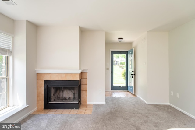 1615 Foxmeadow Cir Unit 1615, Royersford, PA 19468 - unfurnished living room with carpet flooring, a tile fireplace, tile patterned floors, and baseboards