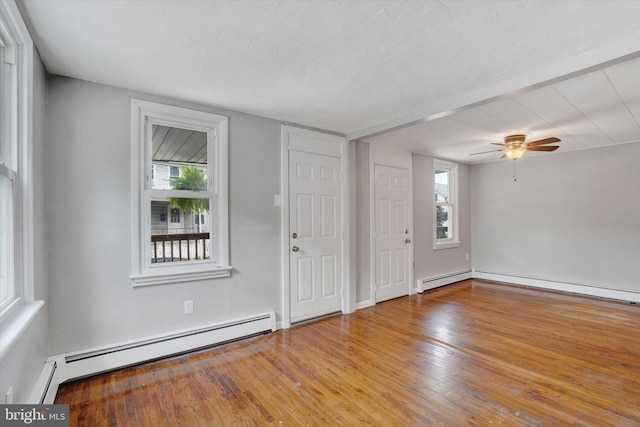 137 S Main St, Yoe, PA 17313 - foyer entrance featuring a baseboard heating unit, plenty of natural light, and wood finished floors