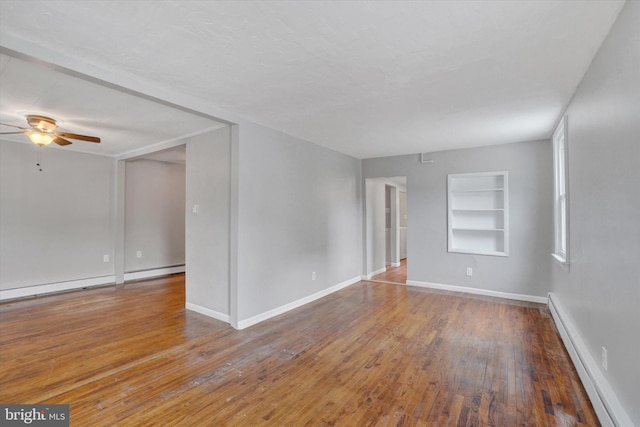 137 S Main St, Yoe, PA 17313 - spare room with a baseboard heating unit, built in features, a ceiling fan, wood finished floors, and baseboards
