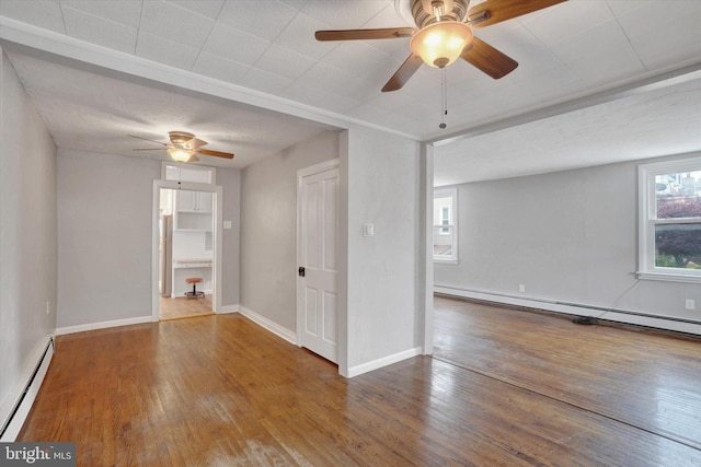 137 S Main St, Yoe, PA 17313 - empty room featuring a baseboard radiator, a ceiling fan, wood-type flooring, and baseboards