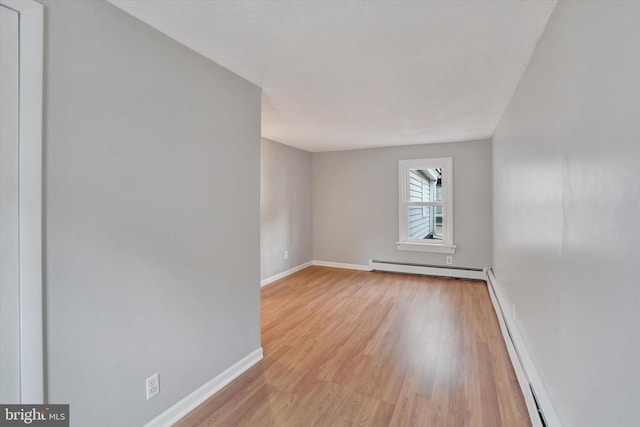 137 S Main St, Yoe, PA 17313 - unfurnished room with light wood finished floors, baseboards, baseboard heating, and a baseboard radiator
