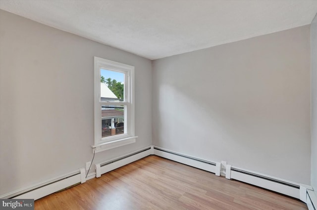 137 S Main St, Yoe, PA 17313 - spare room featuring a baseboard radiator and wood finished floors
