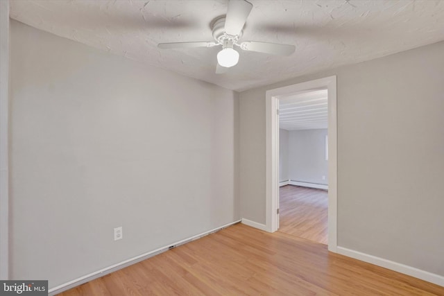 137 S Main St, Yoe, PA 17313 - unfurnished room with wood finished floors, a baseboard radiator, baseboards, and ceiling fan