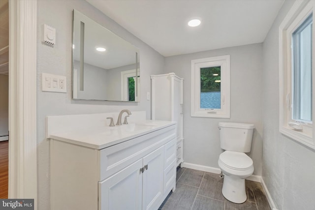 137 S Main St, Yoe, PA 17313 - bathroom with baseboards, toilet, vanity, recessed lighting, and wood finished floors
