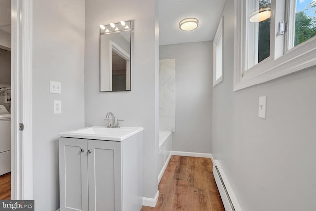 137 S Main St, Yoe, PA 17313 - bathroom featuring wood finished floors, vanity, a tub, and baseboards