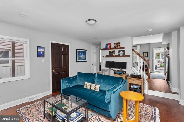 163 2nd St, Bordentown, NJ 08505 - living area featuring wood finished floors, baseboards, and stairway