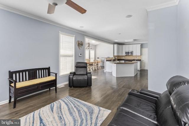 1781 Cobblestone Ln, Vineland, NJ 08361 - living area featuring crown molding, a ceiling fan, dark wood-type flooring, baseboards, and a chandelier