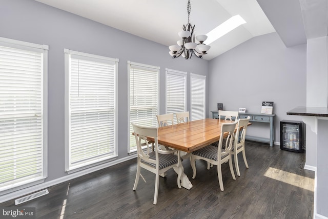 1781 Cobblestone Ln, Vineland, NJ 08361 - dining area with a chandelier, beverage cooler, vaulted ceiling, dark wood-style flooring, and plenty of natural light