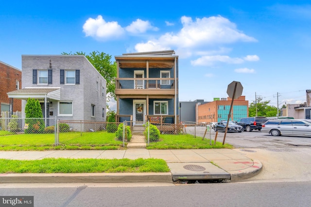 2530 S Dakota Ave NE, Washington, DC 20018 - view of front facade featuring a balcony, a gate, a fenced front yard, and covered porch