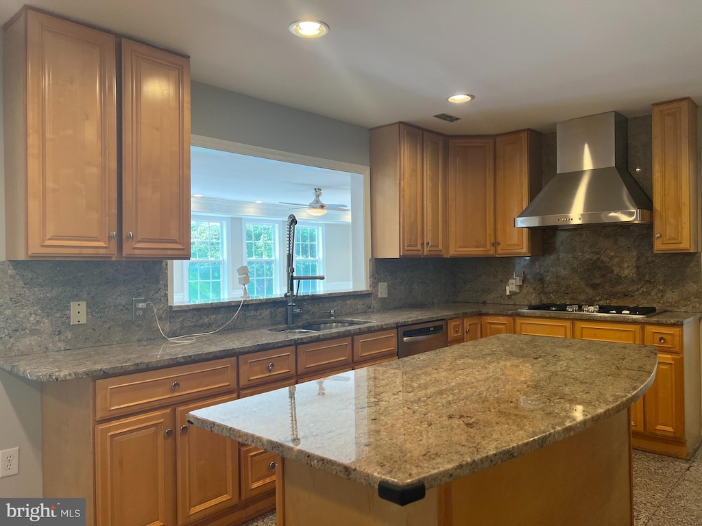 kitchen featuring wall chimney range hood, light stone countertops, decorative backsplash, and recessed lighting