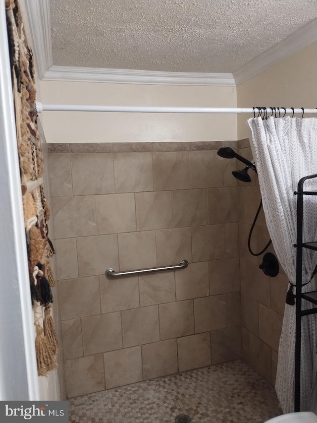 2841 Aquarius Ave, Silver Spring, MD 20906 - bathroom with a tile shower, crown molding, and a textured ceiling