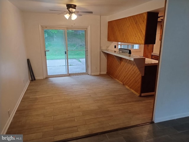 2841 Aquarius Ave, Silver Spring, MD 20906 - kitchen featuring a ceiling fan, plenty of natural light, light countertops, and a kitchen bar
