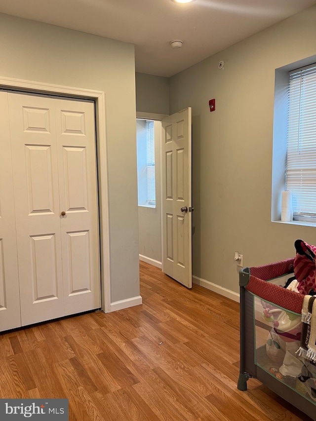 3431 N 19th St, Philadelphia, PA 19140 - bedroom with light wood finished floors, baseboards, multiple windows, and a closet