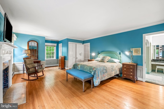 2705 Houcks Mill Rd, Monkton, MD 21111 - bedroom featuring a baseboard radiator, light wood finished floors, a fireplace, a closet, and crown molding