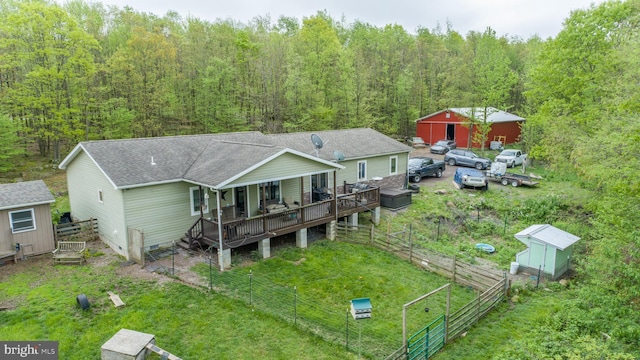 1341 Westview Xing, Grantsville, MD 21536 - rear view of house featuring an outdoor structure, a shed, roof with shingles, a wooden deck, and a view of trees