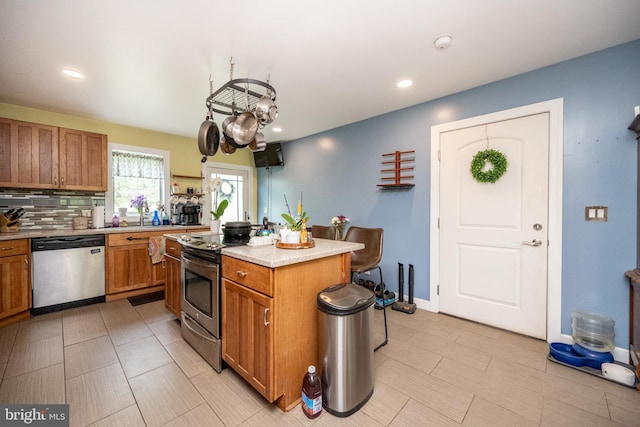 1341 Westview Xing, Grantsville, MD 21536 - kitchen with appliances with stainless steel finishes, brown cabinetry, light countertops, a center island, and recessed lighting