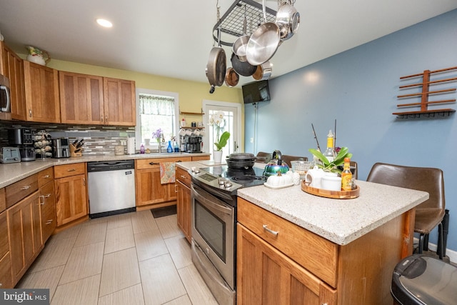 1341 Westview Xing, Grantsville, MD 21536 - kitchen featuring stainless steel appliances, a kitchen island, tasteful backsplash, brown cabinetry, and recessed lighting