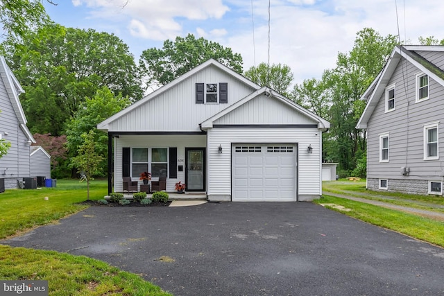 608 Salem Ave, Woodbury, NJ 08096 - view of front of house with a porch, an attached garage, a front yard, and asphalt driveway