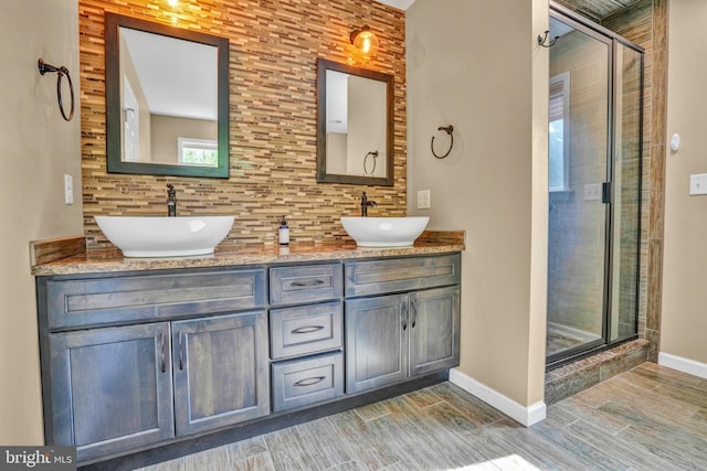 40 Steeple Ct, Reinholds, PA 17569 - bathroom with tasteful backsplash, wood tiled floors, a shower stall, baseboards, and double vanity