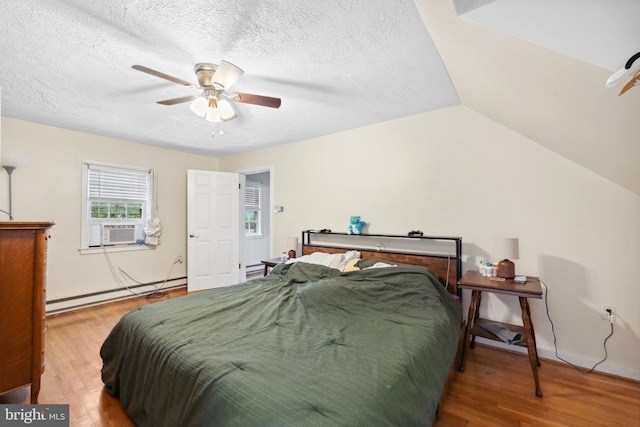 904 W Burke St, Martinsburg, WV 25401 - bedroom with baseboard heating, wood finished floors, a textured ceiling, ceiling fan, and vaulted ceiling