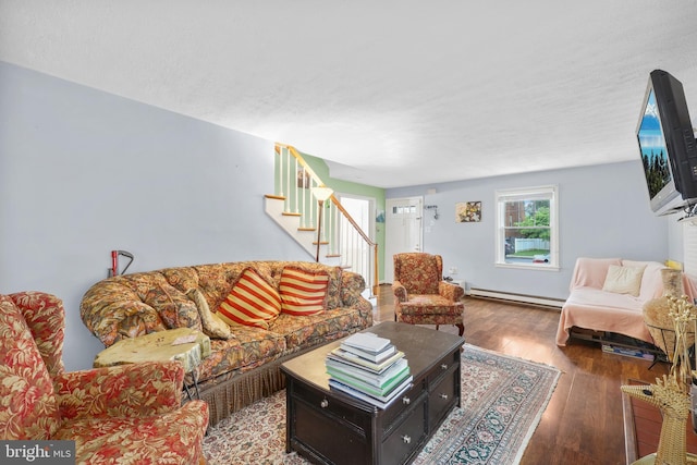 904 W Burke St, Martinsburg, WV 25401 - living area with a baseboard heating unit, stairs, and hardwood / wood-style flooring