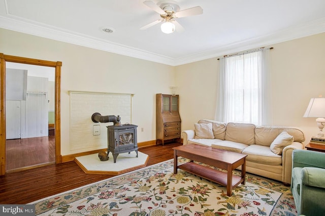 22350 Old Hundred Rd, Barnesville, MD 20838 - living area featuring a wood stove, ornamental molding, ceiling fan, wood finished floors, and baseboards
